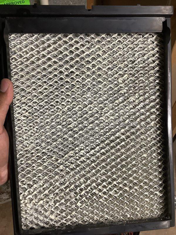 Completed annual cooling maintenance on residential air conditioning system. Inspected and replaced dirty air filter with accumulated dust and debris, ensuring proper airflow and system efficiency. Documented equipment condition with photos showing filter contamination levels and verified system operational status with approval tag placement.