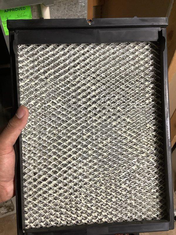 Completed annual cooling maintenance on residential air conditioning system. Inspected and replaced dirty air filter with accumulated dust and debris, ensuring proper airflow and system efficiency. Documented equipment condition with photos showing filter contamination levels and verified system operational status with approval tag placement.