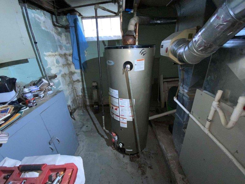 Conducted on-site assessment for tankless water heater installation in basement utility area to replace non-operational conventional tank-style water heater. Evaluated existing natural gas supply line, venting configuration, electrical requirements, and spatial constraints for tankless unit conversion, documenting current equipment conditions and mechanical systems layout to provide comprehensive estimate for equipment upgrade.