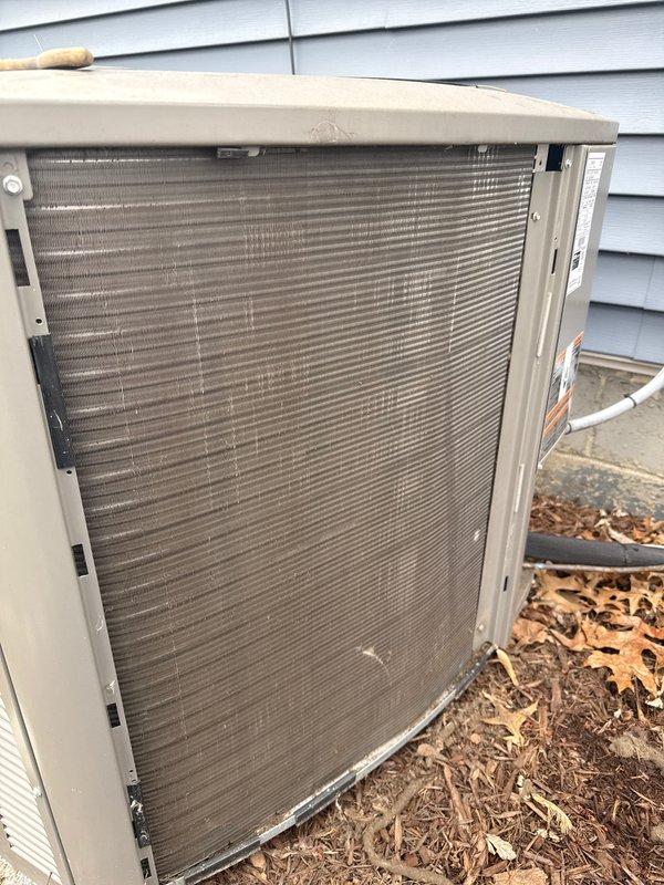 Completed annual cooling maintenance on outdoor heat pump unit. Upon arrival, discovered outdoor coil filter screen heavily clogged with dirt, dust, and organic debris, significantly restricting airflow. Removed and cleaned filter screen, inspected condenser coil fins for damage, and verified unit structural integrity. All components operational following maintenance.