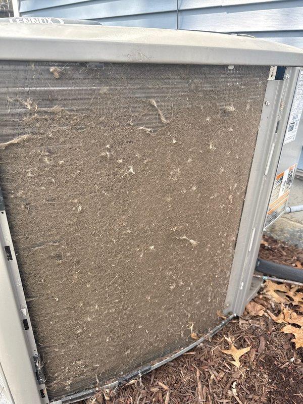 Completed annual cooling maintenance on outdoor heat pump unit. Upon arrival, discovered outdoor coil filter screen heavily clogged with dirt, dust, and organic debris, significantly restricting airflow. Removed and cleaned filter screen, inspected condenser coil fins for damage, and verified unit structural integrity. All components operational following maintenance.