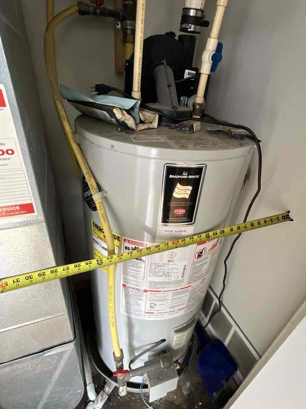 Conducted water heater replacement estimate for a non-functioning 20-year-old Bradford White gas water heater located in kitchen utility closet. Assessed existing installation including gas line connections, PVC venting system, electrical components, and plumbing configurations. Provided options for both natural gas and electric water heater replacements per customer request.