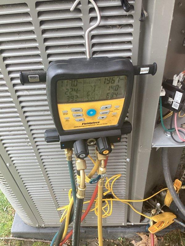 Completed scheduled Air Care Cooling maintenance on outdoor condensing unit. Connected digital manifold gauges and performed comprehensive system diagnostics, recording temperature differentials and refrigerant pressures. Unit showed normal operating parameters with superheat and subcooling within manufacturer specifications. Inspected condenser coil, cabinet condition, and electrical connections. Documented equipment condition with photos for service records.