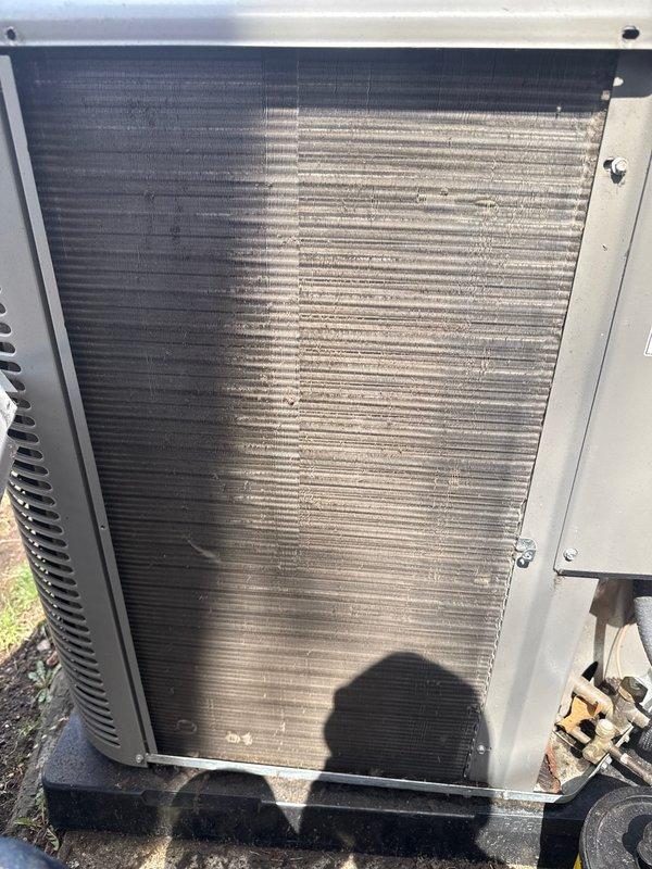 Completed comprehensive preventative maintenance inspection on Goodman HVAC system including both heating and cooling components. Performed routine air handler and condenser unit servicing, documented equipment condition with interior cabinet and outdoor coil photography showing moderate dirt accumulation on heat exchanger surfaces requiring cleaning attention. All mechanical components, electrical connections, blower motor assembly, and refrigerant lines inspected and found operational within normal parameters.