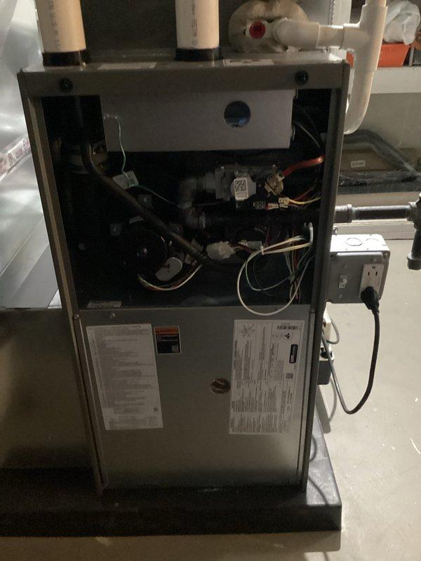 Completed comprehensive Air Care heating and cooling maintenance service on residential HVAC system. Performed seasonal inspection of outdoor air conditioning unit, which exhibited significant filter and coil contamination requiring thorough cleaning. Addressed heavily soiled condenser with accumulated dirt, dust, and debris buildup on exterior panels and ventilation components. Inspected indoor furnace unit with access panel removed to evaluate internal components including blower motor assembly, gas connections, refrigerant lines, electrical wiring harnesses, and condensate drain system. Verified proper operation of all mechanical and electrical systems. Brought replacement humidifier pad as noted in service call prerequisites to ensure optimal indoor air quality during heating season.