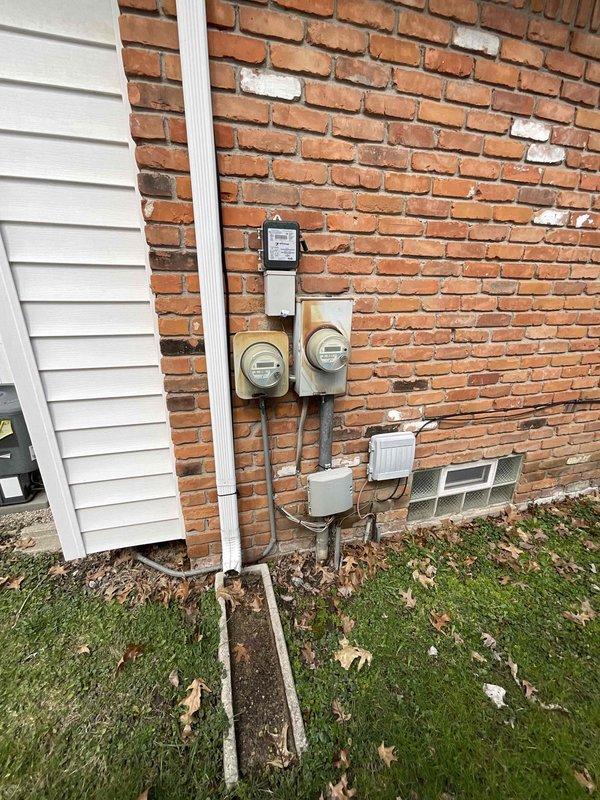 Completed on-site assessment for full HVAC system replacement including 27-year-old furnace from 1999 and existing air conditioning unit operating below optimal capacity. Documented current equipment configuration, photographed exterior condenser unit on gravel pad with refrigerant lines, utility connections, and venting arrangements to prepare comprehensive replacement quote as part of promotional offering.