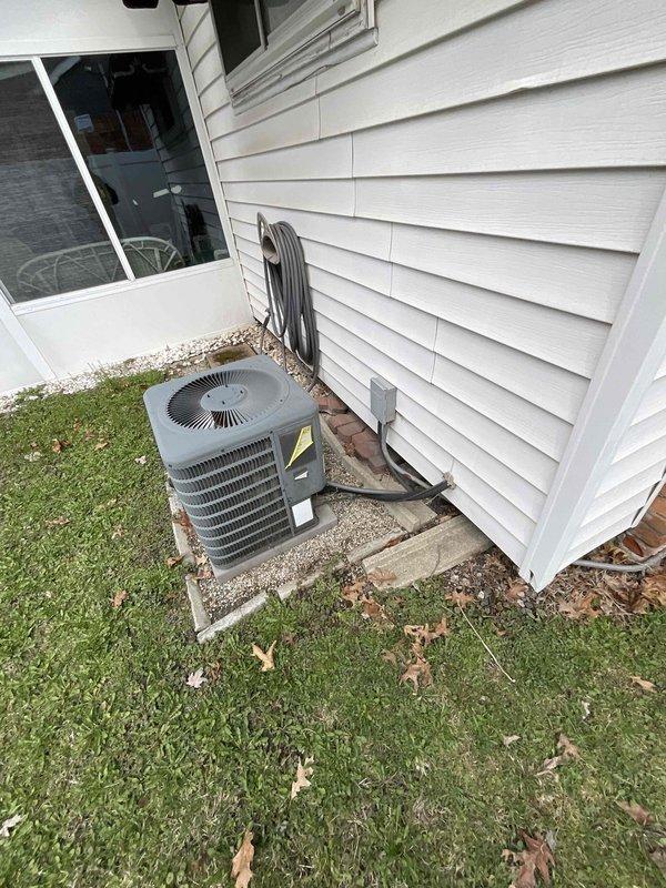 Completed on-site assessment for full HVAC system replacement including 27-year-old furnace from 1999 and existing air conditioning unit operating below optimal capacity. Documented current equipment configuration, photographed exterior condenser unit on gravel pad with refrigerant lines, utility connections, and venting arrangements to prepare comprehensive replacement quote as part of promotional offering.