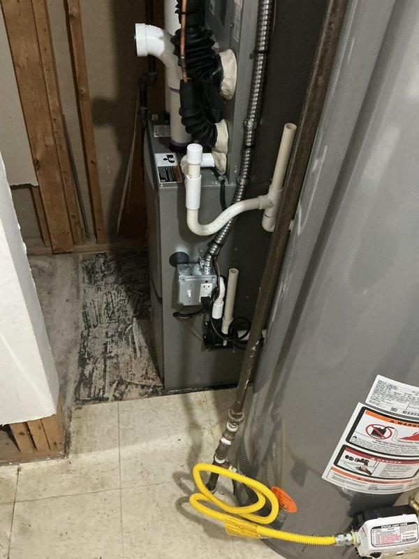 Completed full HVAC system installation including a 70,000 BTU furnace and 2-ton air conditioning unit with rear discharge configuration. Installed all necessary PVC condensate drainage lines, electrical connections, and ductwork transitions in mechanical room. All required mechanical and electrical permits were obtained prior to installation, and existing utility connections were successfully reconnected to the new equipment.