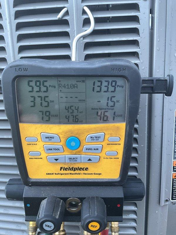 Returned to property for follow-up diagnostic on refrigerant leak concern. Utilized Fieldpiece SMAN manifold gauge set to measure system pressures and temperatures, recording readings of 59.5 PSIG low side and 133.9 PSIG high side with superheat analysis. Performed UV leak detection inspection using blacklight to identify fluorescent dye traces indicating potential leak points in the system. Senior technician conducted comprehensive evaluation to determine root cause of ongoing refrigeration issue and provided technical findings to address customer concerns.