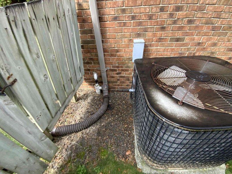 Completed full system estimate for HVAC replacement at residential property. Existing 30+ year old furnace with cracked heat exchanger and air handler unit located in basement utility area requires replacement due to safety concerns and end of serviceable life. Documented current indoor equipment configuration including wall-mounted air handler with flexible ductwork and aging furnace cabinet, as well as outdoor condenser unit positioned on concrete pad against brick exterior wall. Provided comprehensive replacement options for complete heating and cooling system to address immediate safety hazard and restore reliable climate control.