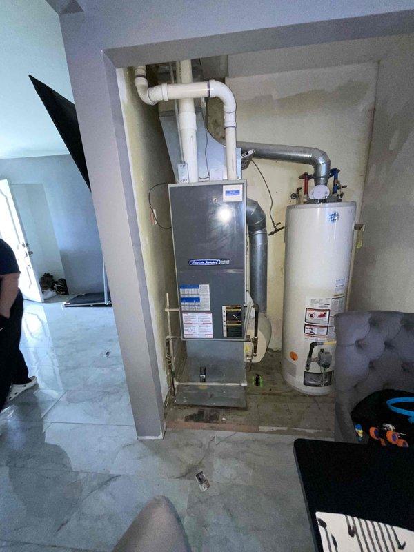 Conducted site evaluation for new air conditioning system installation in residential property with no existing AC equipment. Assessed existing HVAC infrastructure including American Standard furnace and utility room layout to determine optimal installation approach for new cooling system. Documented existing ductwork configuration and mechanical room space constraints to develop installation plan for expedited AC system integration with current heating equipment.