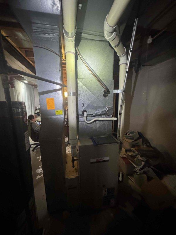 Provided estimate for replacement of non-operational 20-year-old furnace located in basement. Customer expressed interest in Lennox high-efficiency furnace system. Assessed existing HVAC infrastructure including ductwork configuration, venting system with PVC piping, and current equipment layout in mechanical room to determine compatibility and installation requirements for proposed high-efficiency replacement unit.