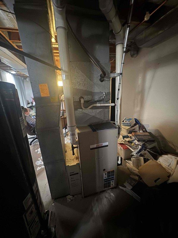 Provided estimate for replacement of non-operational 20-year-old furnace located in basement. Customer expressed interest in Lennox high-efficiency furnace system. Assessed existing HVAC infrastructure including ductwork configuration, venting system with PVC piping, and current equipment layout in mechanical room to determine compatibility and installation requirements for proposed high-efficiency replacement unit.