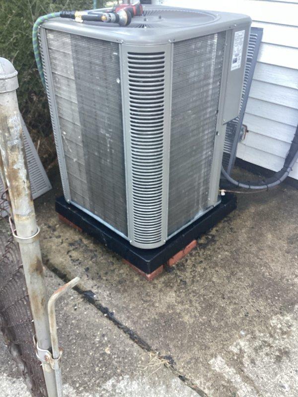 Completed annual maintenance on residential split system air conditioning unit. Performed comprehensive inspection of outdoor condenser including cleaning of coils, verification of refrigerant levels, electrical connections check, and operational testing of compressor and fan motor. Unit found in good working condition with normal wear patterns. Documented equipment condition with photos showing proper installation on pad with appropriate clearances and functioning components.