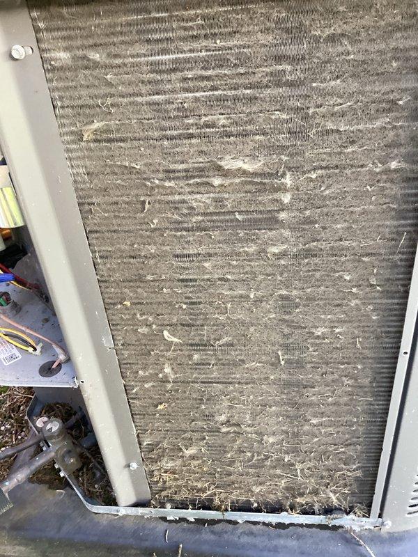 Completed comprehensive tune-up service on residential HVAC system. Performed thorough cleaning of heavily soiled outdoor condenser coil which exhibited significant accumulation of dust, debris, and particulate matter restricting airflow. Cleaned indoor evaporator coil that displayed extensive buildup of lint, household dust, and fibrous materials throughout fin surfaces. Replaced air filter and verified all system components operating within normal parameters upon completion.