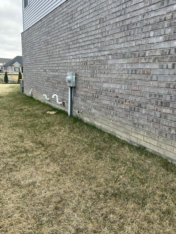 Completed electrical assessment for Level 2 EV charging station installation at residential property. Evaluated existing electrical infrastructure including main service panel location in basement area and exterior meter placement on building's side wall. Documented current electrical capacity, panel accessibility, and optimal conduit routing path from main panel to proposed charging station location to ensure safe and code-compliant installation.