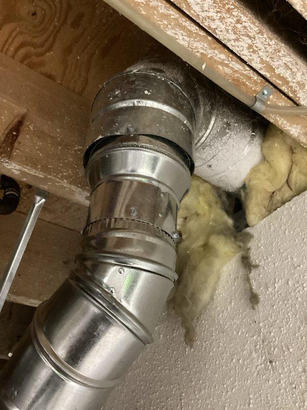 Completed installation of 40-gallon tanked water heater in residential basement utility area. Unit was properly positioned and secured against concrete wall with all necessary plumbing connections made, including hot and cold water supply lines. Metallic exhaust vent pipe was installed and routed upward through ceiling structure with proper elbow configuration to ensure safe ventilation of combustion gases. All connections were tested for proper operation and leak-free performance. Installation was completed in accordance with applicable building codes, and required permits were obtained prior to work commencement.