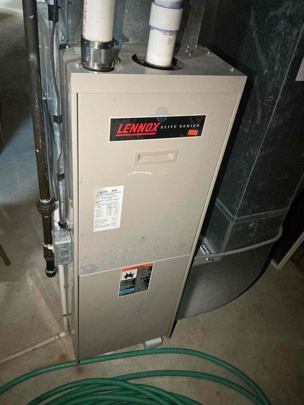 Conducted comprehensive site evaluation for HVAC system replacement estimate at residential property with existing Lennox Elite Series LP furnace located in basement. Assessed current electrical infrastructure including circuit breaker panel with dedicated HVAC circuits, evaluated existing furnace installation and venting configuration with PVC exhaust system, and documented equipment specifications for air conditioning addition to property currently without cooling system.