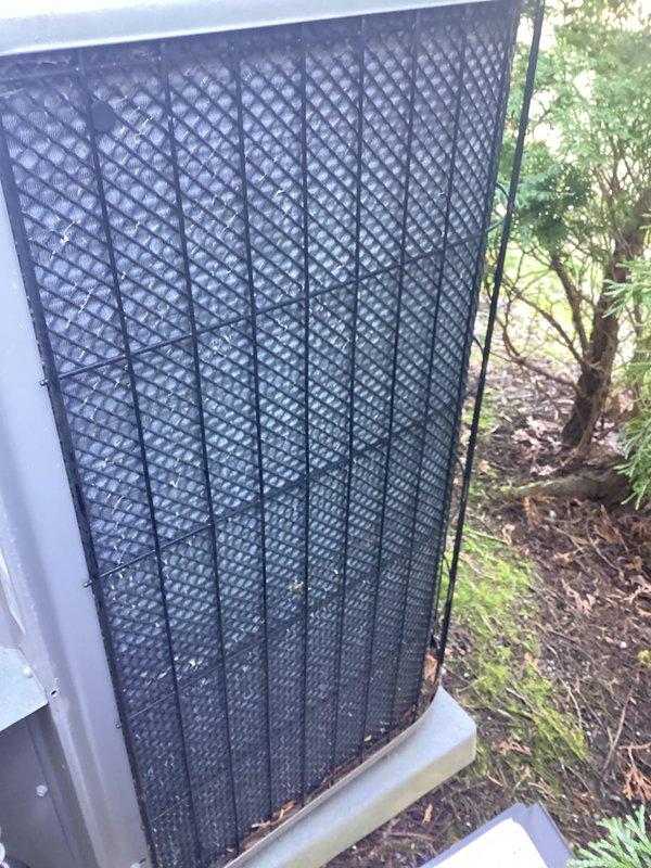 Completed annual preventive maintenance on residential cooling system. Inspected outdoor condenser unit, verified operational status of all components, and documented equipment condition. Unit showed normal weathering with surface debris accumulation on protective grille panels, consistent with outdoor exposure.