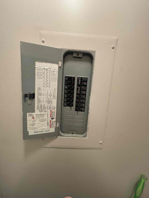 Conducted site evaluation for replacement of combo packaged HVAC unit in apartment setting. Assessed existing equipment housed in dedicated utility closet, documented electrical panel configuration with approximately 16-20 circuit breakers, and inspected current furnace/air handler installation with connected ductwork and plenum. Noted significant floor staining and water damage around base of existing unit indicating previous moisture intrusion issues that will require remediation during replacement process.
