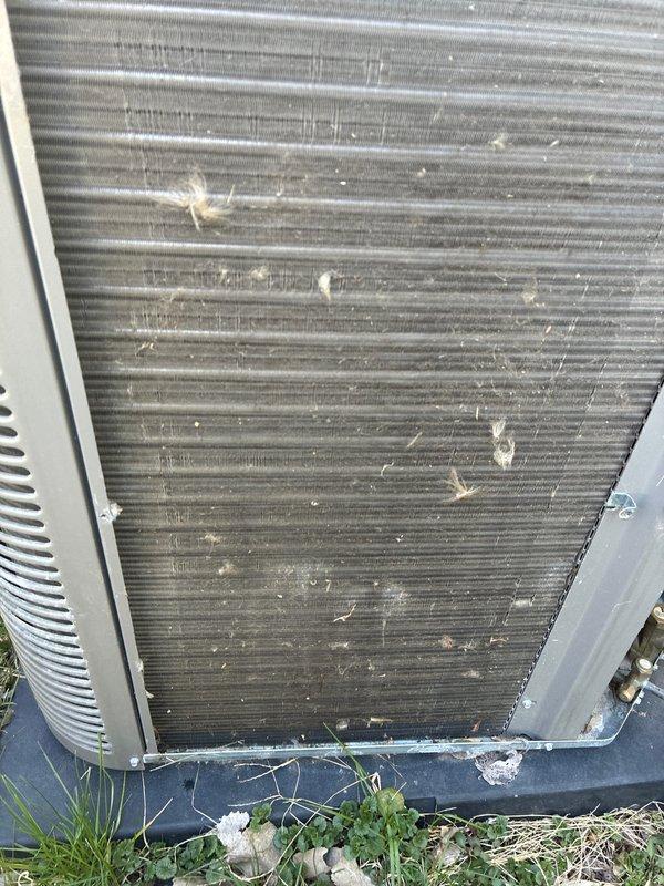 Completed annual cooling maintenance on residential HVAC system. Condenser coils exhibited heavy accumulation of dirt, dust, and environmental debris with significant clogging throughout fin surfaces. Thoroughly cleaned condenser coils to restore proper airflow and heat transfer efficiency. Replaced air filters and evaporator pad as scheduled. Unit operational upon completion with improved airflow and system performance.