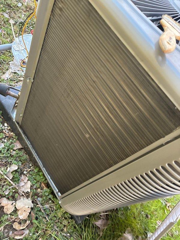 Completed annual cooling maintenance on residential HVAC system. Condenser coils exhibited heavy accumulation of dirt, dust, and environmental debris with significant clogging throughout fin surfaces. Thoroughly cleaned condenser coils to restore proper airflow and heat transfer efficiency. Replaced air filters and evaporator pad as scheduled. Unit operational upon completion with improved airflow and system performance.