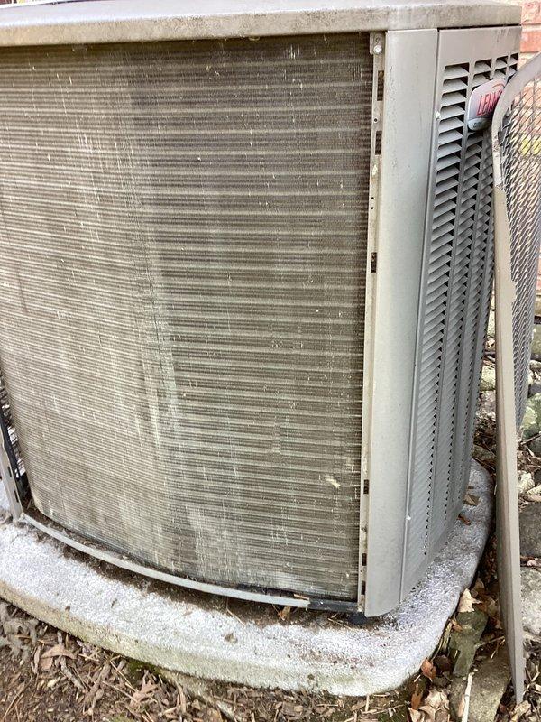 Completed comprehensive air conditioning tune-up on outdoor condensing unit. Upon arrival, found evaporator coil fins heavily clogged with accumulated dirt, debris, and grime, significantly restricting airflow. Removed access panel, which showed substantial deterioration with large tear exposing internal components. Thoroughly cleaned condenser coils to restore proper heat transfer efficiency, removed debris from base and surrounding area, and verified system operation. Unit returned to optimal working condition with improved airflow and cooling capacity.