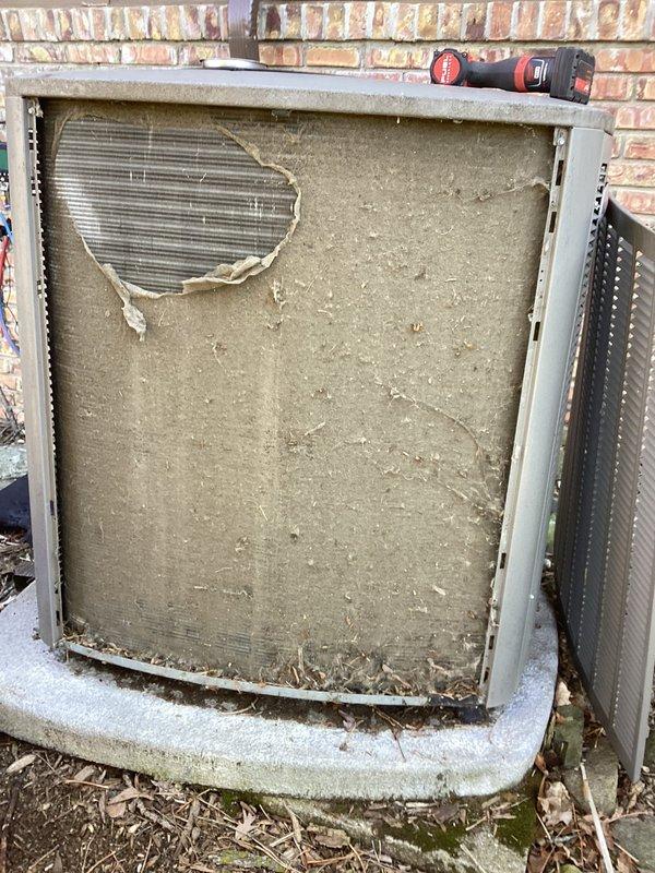 Completed comprehensive air conditioning tune-up on outdoor condensing unit. Upon arrival, found evaporator coil fins heavily clogged with accumulated dirt, debris, and grime, significantly restricting airflow. Removed access panel, which showed substantial deterioration with large tear exposing internal components. Thoroughly cleaned condenser coils to restore proper heat transfer efficiency, removed debris from base and surrounding area, and verified system operation. Unit returned to optimal working condition with improved airflow and cooling capacity.