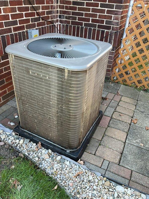 Completed ComfortGuard preventive maintenance service on residential outdoor air conditioning condenser unit. Performed comprehensive AC/coil only maintenance protocol including visual inspection of cabinet condition, verification of proper unit placement on equipment pad, assessment of airflow clearances around all sides of the condenser, and examination of top discharge grille and fan assembly. Unit found to be in serviceable condition with normal weathering consistent with outdoor installation. Condenser positioned appropriately on protective pad with adequate drainage and clearance from surrounding structures. All accessible components inspected and system ready for cooling season operation.