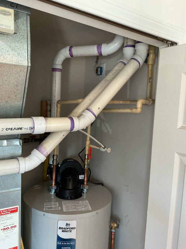 Installed a 50-gallon Bradford White power vent water heater in residential utility closet. Completed all necessary plumbing connections using copper and PEX piping with appropriate fittings and shut-off valves. Secured circulation pump with proper electrical connections and verified all mechanical connections for proper operation per manufacturer specifications.