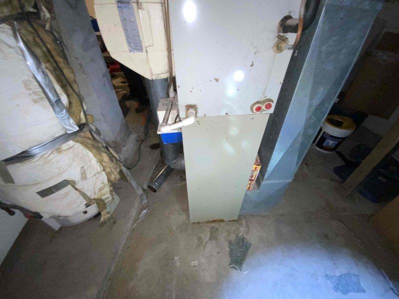 Provided estimate for replacement of non-functional 20-year-old furnace and air conditioning system located in basement. Assessed existing HVAC equipment, ductwork configuration, and utility space layout to determine proper sizing and installation requirements for new system under furnace and air conditioning replacement promotion.