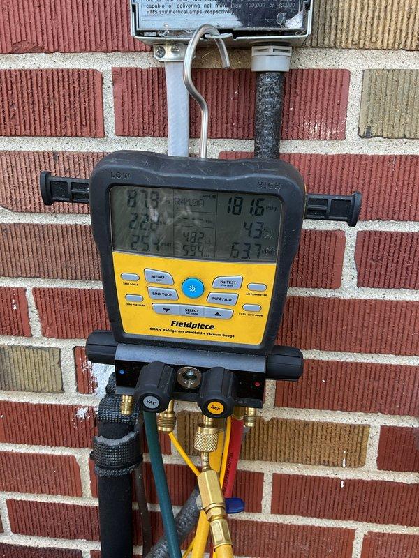 Performed annual cooling maintenance on York air conditioning system. Connected digital manifold gauges to measure refrigerant pressures and verify system operating parameters. Inspected condenser unit exterior condition, coil cleanliness, and confirmed proper airflow through protective grille. All system readings within normal operating range, unit functioning as designed.