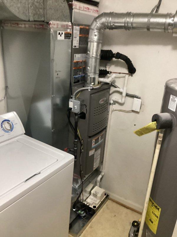 Completed full HVAC system installation in residential utility room, including 70,000 BTU gas furnace with left-side configuration and 2-ton air conditioning unit. Installed galvanized metal supply ductwork with proper mounting brackets and flexible duct connectors, ensuring secure attachment to furnace plenum. Connected all necessary refrigerant lines, condensate drainage, electrical wiring, and gas piping per code requirements. Integrated RCONNECT smart thermostat system for remote monitoring and control capabilities. All mechanical and electrical permits obtained prior to installation. System tested and verified for proper operation, airflow, and temperature control upon completion.