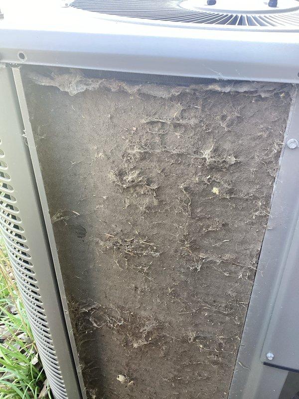 Completed annual cooling maintenance on outdoor HVAC unit. Inspected and cleaned heavily clogged air filter screen showing significant accumulation of dirt, dust, debris, and organic matter that was restricting airflow. Cleaned condenser coil fins which displayed substantial dirt buildup, discoloration, and debris accumulation across lower section that would impede heat transfer efficiency. Verified proper operation of unit following cleaning procedures.
