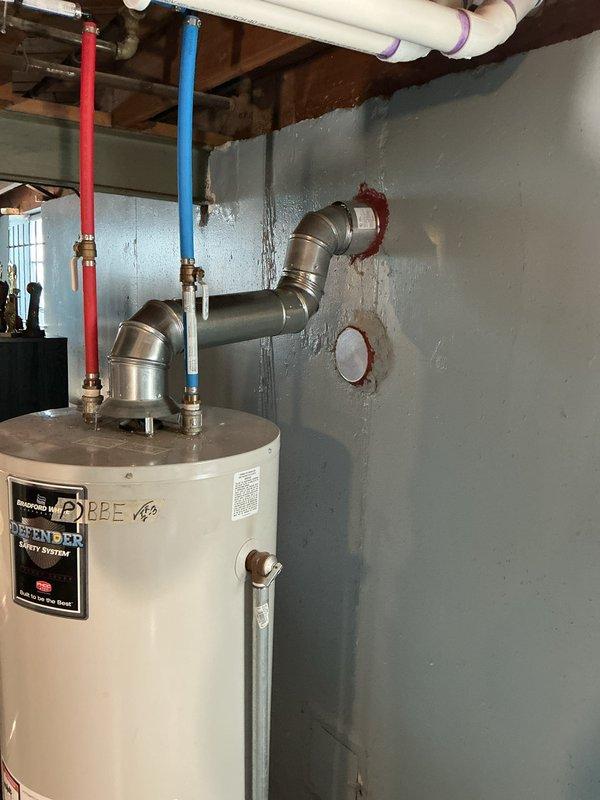 Completed furnace-only installation of 70,000 BTU unit in basement mechanical room. Obtained mechanical and electrical permits prior to installation, installed new furnace with proper venting and flue liner, connected to existing ductwork plenum, and reconnected all electrical components per code requirements.