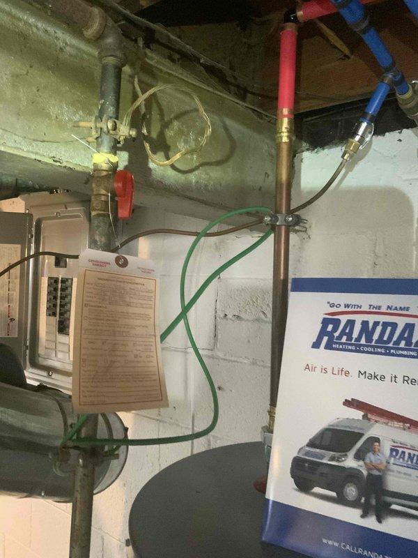 Conducted comprehensive assessment of basement HVAC system for replacement estimate. Evaluated existing natural gas furnace and air conditioning equipment, noting operational status and configuration within basement mechanical room. Documented significant environmental concerns including extensive moisture damage and biological growth on floor surfaces surrounding equipment area, which will require remediation prior to new system installation. Photographed existing equipment layout, ductwork connections, electrical components, and plumbing configurations to develop accurate replacement specifications and ensure proper sizing for new high-efficiency system.
