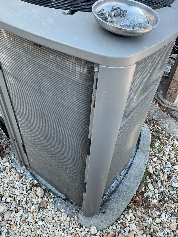 Completed routine air conditioning maintenance on outdoor condenser unit. Performed standard ACM inspection, removed and cleaned top grille assembly with hardware stored in collection pan during service, verified unit operational status, and reassembled equipment. Unit operating within normal parameters upon completion of maintenance procedures.