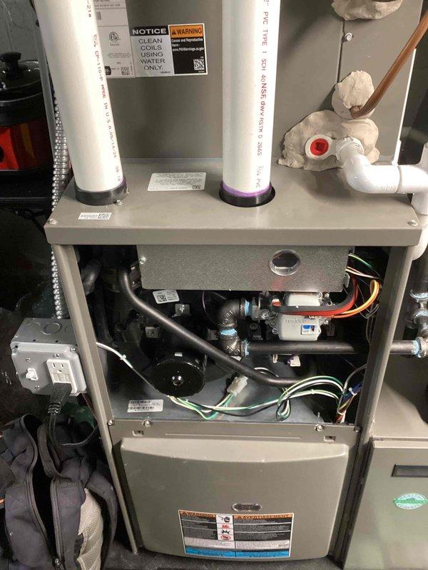 Responded to service call for furnace vibrating the floor in living room and condensate pump tripping GFCI outlet. Performed comprehensive inspection of furnace system with access panels removed to assess internal components, mounting hardware, and mechanical assemblies. Inspected blower motor, electrical connections, condensate pump operation, and all associated piping and drainage systems. Documented system conditions with photographs for service records as part of recurring Air Care Heating and Cooling maintenance program.