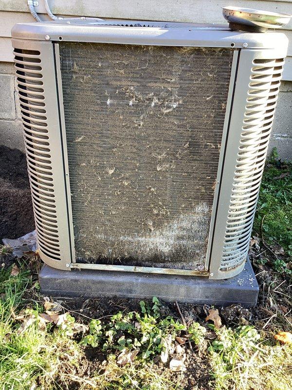 Completed annual cooling maintenance on residential air conditioning system. Upon inspection, found condenser unit with heavily soiled filter screen and accumulated dirt and debris covering front panel, significantly restricting airflow. Unit also showed signs of age with vegetation growth around base and algae discoloration on lower panels. Cleaned and serviced condenser unit, removing all debris and buildup from filter screens and exterior surfaces. Identified humidifier pad requiring replacement due to deterioration. Replaced humidifier pad to restore proper system operation and indoor air quality. Cleared vegetation and debris from around unit base to ensure adequate clearance and airflow. Verified all mechanical and electrical components operating within normal parameters following maintenance completion. System restored to optimal operating condition.
