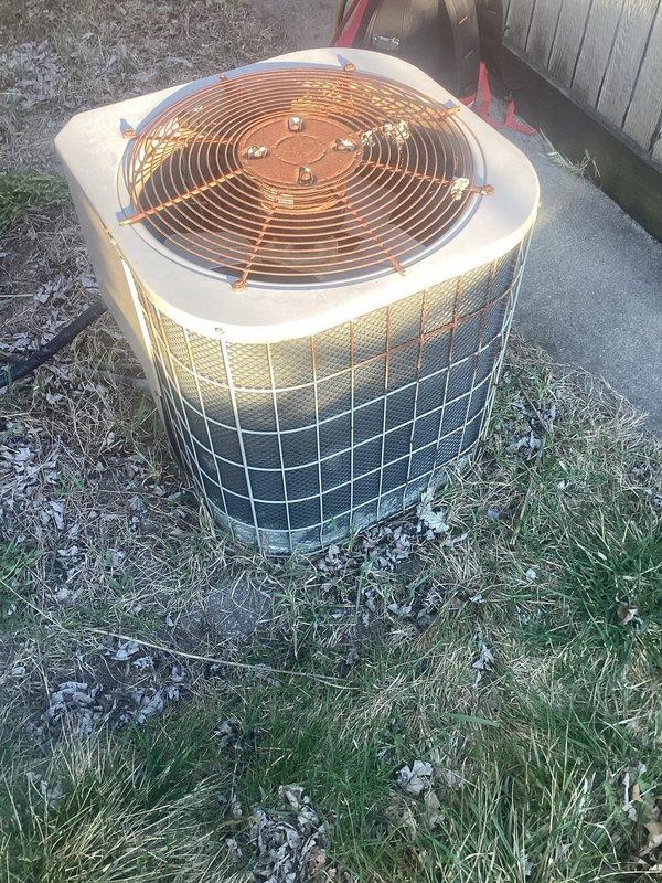 Responded to no-cooling complaint on residential air conditioning system. Upon arrival, found outdoor condensing unit producing buzzing sound with non-operational condenser fan motor. Inspected fan motor and capacitor assembly, identifying failed fan motor and weak dual run capacitor as root causes. Replaced defective condenser fan motor with OEM equivalent and installed new dual run capacitor to manufacturer specifications. Verified proper electrical connections, tested system operation, and confirmed condenser fan rotation and normal compressor function. Unit now cooling properly with no abnormal sounds. System returned to full operational status.