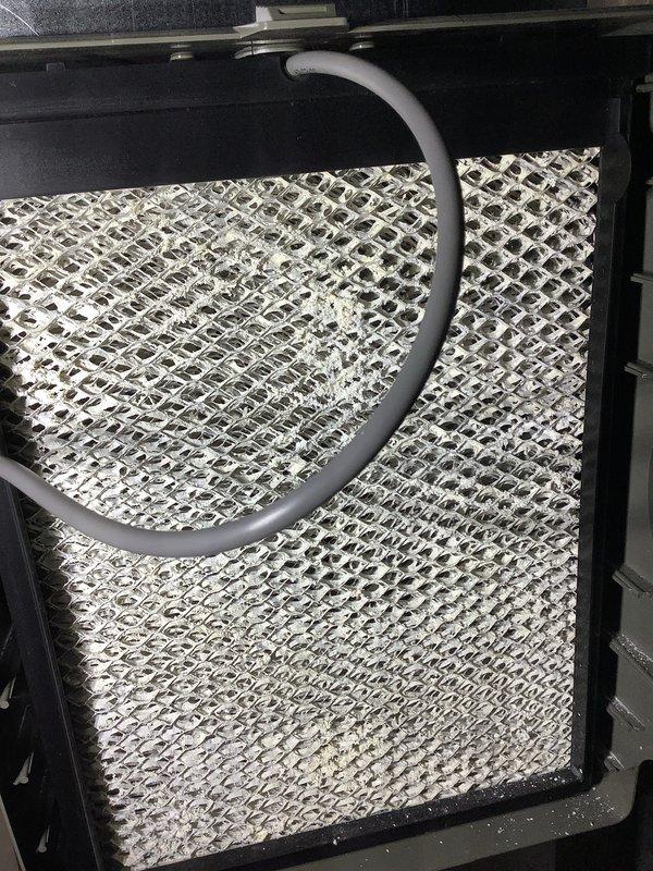 Completed comprehensive Air Care Heating and Cooling maintenance on AHC4/88-11 unit. Inspected evaporator coil assembly with diamond-pattern mesh filter, noting accumulated dust and debris requiring attention, and verified condensate drain line routing and functionality. Documented internal HVAC components including evaporator coil with horizontal fins, refrigerant lines, electrical connections with proper wire management, safety controls, and mounting hardware, confirming all systems operational and properly secured.