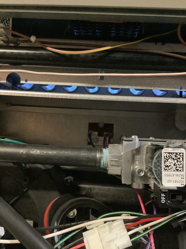 Completed comprehensive Air Care Heating and Cooling maintenance on AHC4/88-11 unit. Inspected evaporator coil assembly with diamond-pattern mesh filter, noting accumulated dust and debris requiring attention, and verified condensate drain line routing and functionality. Documented internal HVAC components including evaporator coil with horizontal fins, refrigerant lines, electrical connections with proper wire management, safety controls, and mounting hardware, confirming all systems operational and properly secured.