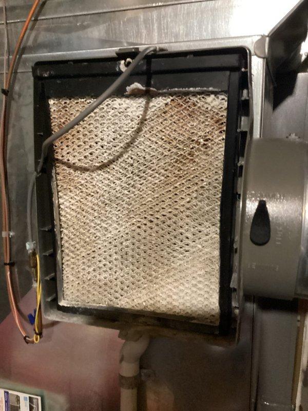 Completed annual cooling maintenance on residential HVAC system. Inspected indoor air handler and found heavily soiled air filter with significant dust and debris accumulation, restricting airflow to the system. Examined outdoor condensing unit and documented extensively clogged condenser coils with thick buildup of dirt, dust, and environmental debris between fins, severely impacting heat transfer efficiency and system performance. Both components showed signs of extended operation without regular maintenance, requiring attention to restore proper system function and prevent premature equipment failure.