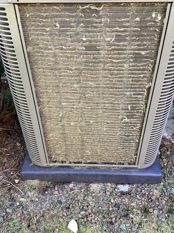 Completed annual cooling maintenance on residential HVAC system. Inspected indoor air handler and found heavily soiled air filter with significant dust and debris accumulation, restricting airflow to the system. Examined outdoor condensing unit and documented extensively clogged condenser coils with thick buildup of dirt, dust, and environmental debris between fins, severely impacting heat transfer efficiency and system performance. Both components showed signs of extended operation without regular maintenance, requiring attention to restore proper system function and prevent premature equipment failure.