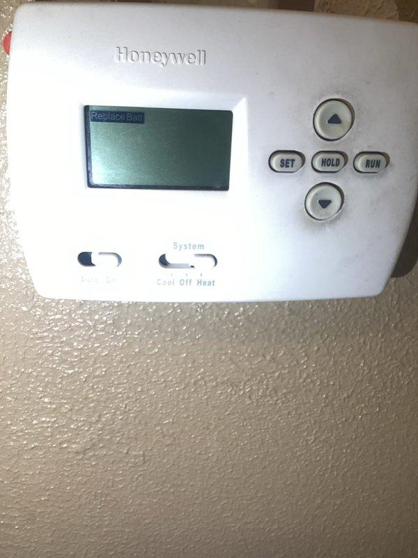 Responded to no-heat call on 11+ year old furnace system located in basement. Upon arrival, found Honeywell programmable thermostat displaying low battery warning message. Removed thermostat from wall mount and replaced depleted batteries. Verified thermostat display restored to proper function showing heat call at 71-degree setpoint with current temperature reading of 53 degrees. Confirmed system communication restored and heating cycle initiated successfully.