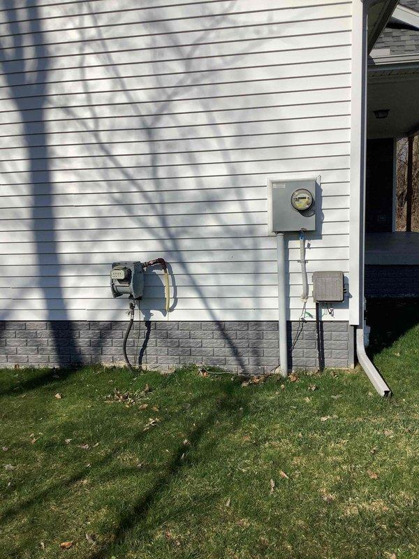 Completed electrical estimate for new whole home generator installation at residential property. Assessed existing electrical service panel location in basement utility area and evaluated exterior meter placement on side wall for generator connection requirements. Documented current electrical infrastructure including main service entrance, meter configuration, and available space for generator placement and necessary transfer switch installation to provide comprehensive quote for standby generator system.