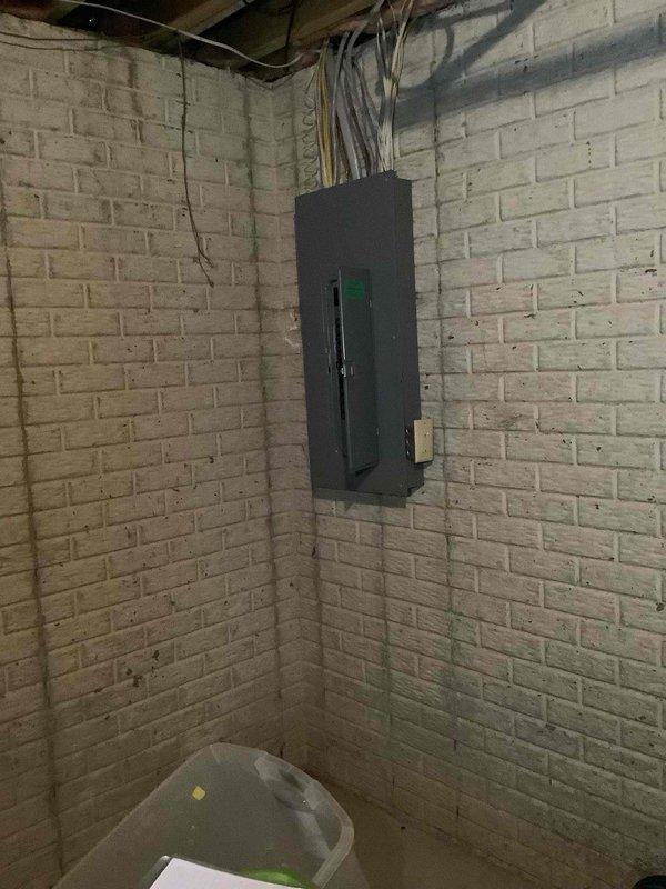 Completed electrical estimate for new whole home generator installation at residential property. Assessed existing electrical service panel location in basement utility area and evaluated exterior meter placement on side wall for generator connection requirements. Documented current electrical infrastructure including main service entrance, meter configuration, and available space for generator placement and necessary transfer switch installation to provide comprehensive quote for standby generator system.