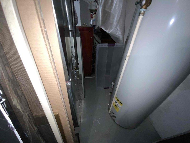 Provided comprehensive estimate for replacement of 15-year-old furnace and air conditioning system located in basement mechanical room. Current equipment is operational but nearing end of service life, prompting evaluation for updated HVAC system to improve efficiency and reliability. Assessment included documentation of existing installation configuration, ductwork connections, available clearances in utility space, and coordination requirements with adjacent water heater and plumbing infrastructure.