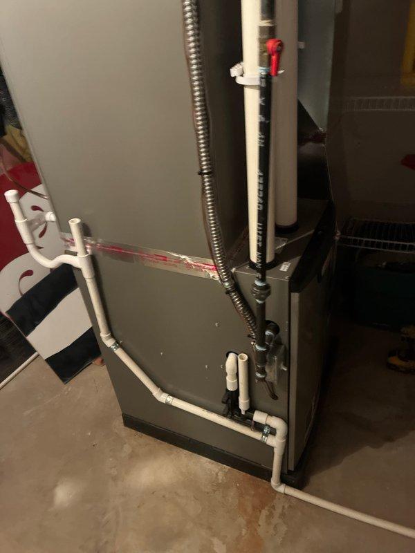 Completed routine maintenance on residential HVAC system including both heating and cooling components. Inspected air handler unit, furnace cabinet, and associated ductwork in basement mechanical room. Verified proper operation of condensate drain lines and PVC piping connections, checked flexible conduit and electrical connections, and examined all accessible components for wear or potential issues. System is operating within normal parameters and ready for continued service.