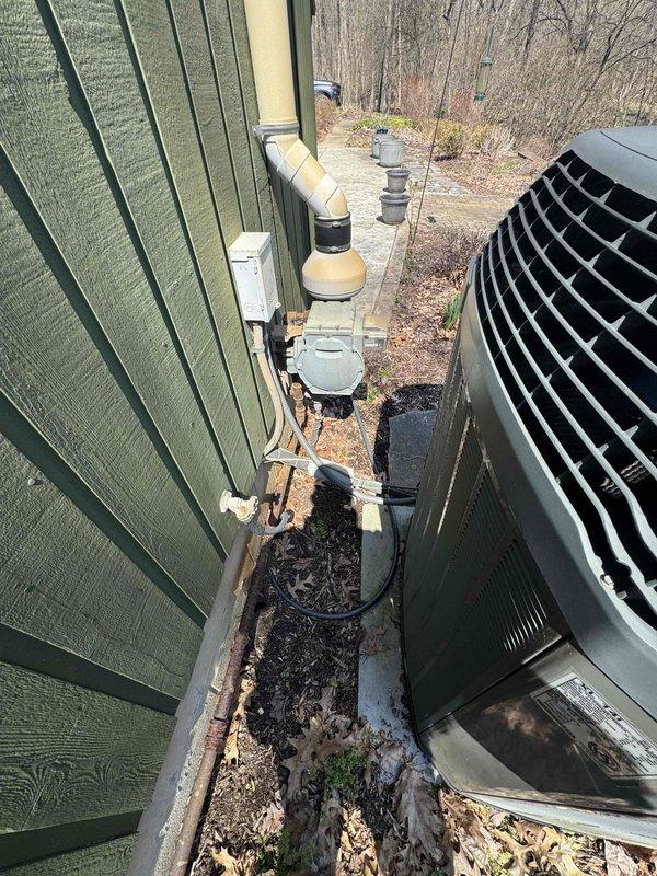Provided estimate for complete HVAC system replacement including furnace and air conditioner under BOGO promotion for basement-installed equipment dating from 2006. Non-functional air conditioning unit and aging furnace require replacement, with exterior condenser unit accessible via narrow side yard passage adjacent to existing electrical service and gas lines.